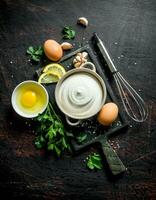 Mayonnaise with eggs, parsley and garlic cloves. photo