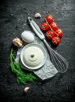 Mayonnaise with garlic, herbs and cherry tomatoes. photo