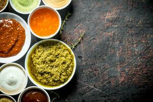 Different types of sauces in bowls. photo