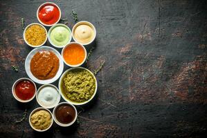 Barbecue sauce, pesto, mayonnaise, mustard with thyme sprigs. photo