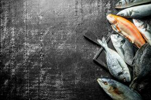 Various fresh fish on wooden cutting Board. photo