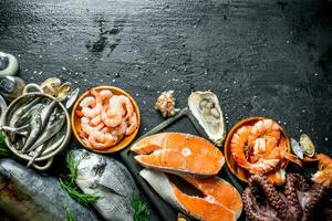 Salmon steak on a cutting Board with seafood. photo