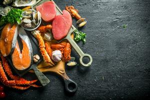 Tuna and salmon steaks on cutting boards. photo