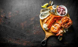 Fresh seafood on a cutting Board with lime and spices. photo