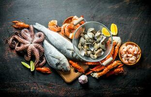 Seafood. Oysters, fresh fish, shrimp, octopus and crab with lemon slices. photo