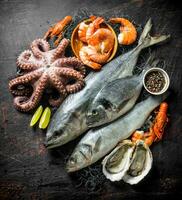 Fresh seafood with spices and lime slices. photo