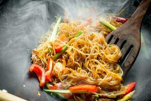 Hot Asian cellophane noodles with vegetables and salmon. photo