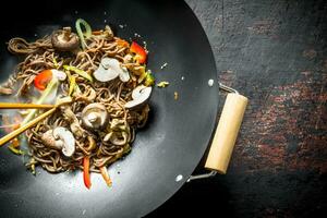 Hot Asian soba noodles with vegetables, mushrooms and sauce. photo