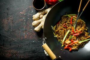 Freshly cooked Chinese noodles wok funchoza with salmon, vegetables and sauce. photo