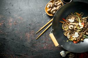 Delicious Chinese soba wok noodles with beef, mushrooms and vegetables. photo