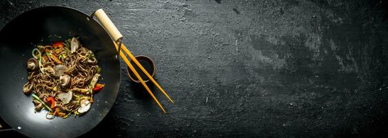 Fragrant soba noodles in a wok pan. photo