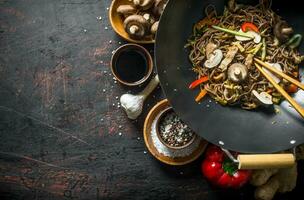 Fragrant Asian soba with spices, beef, vegetables and mushrooms. photo