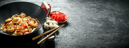 Wok Udon noodles with ginger, soy sauce and bell pepper. photo