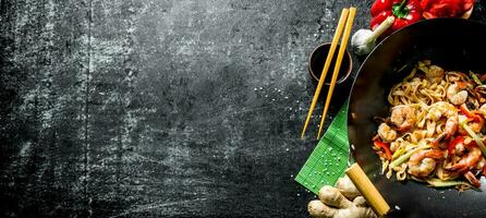 Delicious Chinese Udon noodles with shrimp, sauce and vegetables. photo