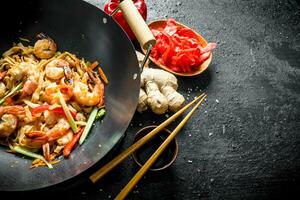 Wok Udon noodles with ginger, soy sauce and bell pepper. photo
