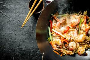 Chinese wok. Hot Udon noodles with shrimp, sauce and vegetables. photo
