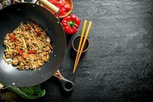 Chinese wok. Asian rice with beef in a wok pan. photo