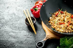 Chinese wok. Asian rice with beef in a wok pan. photo