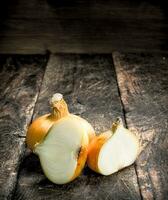 Fresh onions. On wooden background. photo