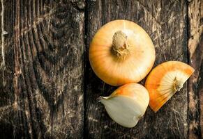 Fresh onions. On wooden background. photo