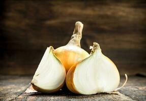 Fresh onions. On wooden background. photo