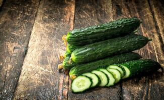 Fresh cucumbers. On wooden background. photo