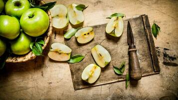 Sliced green apples on a wooden board. photo