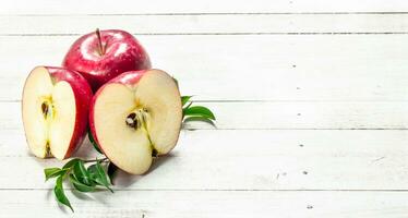 Fresh red apples with leaves. photo