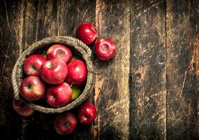 Red ripe apples in a wooden bucket. photo