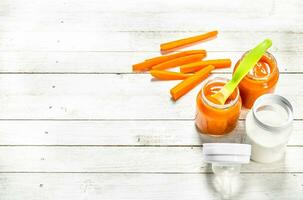 Baby food. Baby carrot puree with milk in a bottle. photo