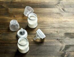Baby food. Baby milk in small bottles. photo