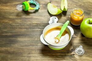 Baby food. Baby puree from green apples. photo