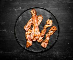 Fried bacon on a plate. photo