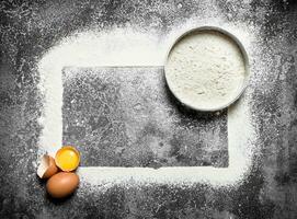 Baking background. Ingredients for the dough with sifted flour. photo