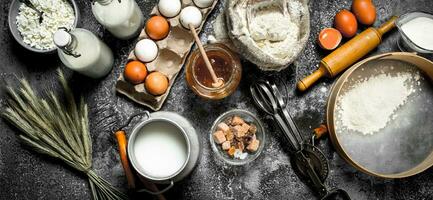 Baking background. Ingredients and tools for dough preparation. photo