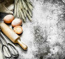 Baking background. Ingredients and tools for dough preparation. photo