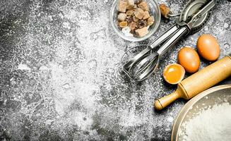 Baking background. Ingredients and tools for dough preparation. photo