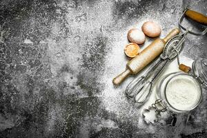 Baking background. Ingredients and tools for dough preparation. photo