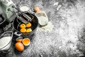 Baking background. Blend eggs with a mixer to make a dough. photo