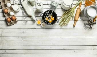 Baking background. Fresh eggs with a mixer. photo