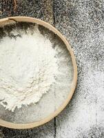 Baking background. Sieve with flour. photo