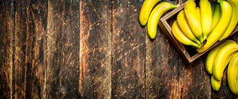 Fresh bananas in an old box. photo