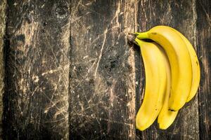 Fresh bananas. On wooden background. photo