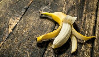 Ripe banana. On wooden background. photo