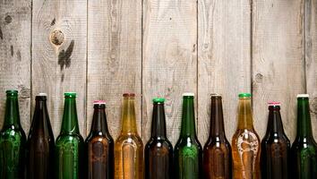 Beer bottles on wooden table . photo