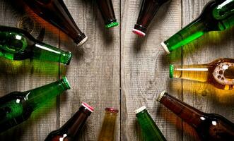 Beer bottles on wooden table . photo