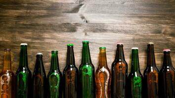 Beer bottles on wooden table . photo