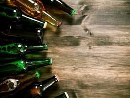 Beer bottles on wooden table . photo