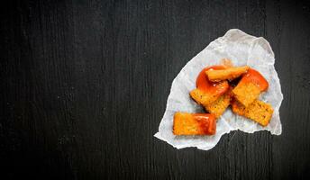 Crackers with ketchup on piece of paper. Free space for text. photo