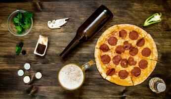 Objects for  pizza party. On a wooden table. photo